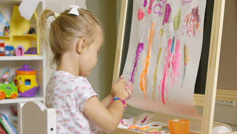 Creative-little-girl-painting-an-abstract-picture