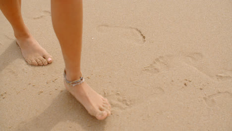 Bare-Feet-Coated-in-Sand-Walking-on-Beach