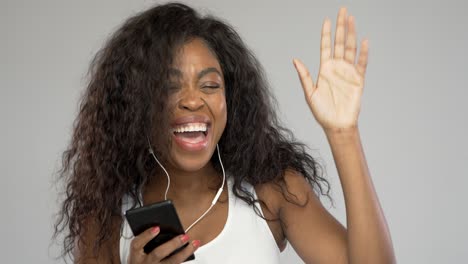 Happy-woman-listening-to-music-and-dancing