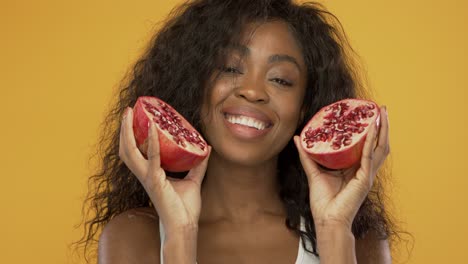 Pleased-black-woman-with-pomegranate