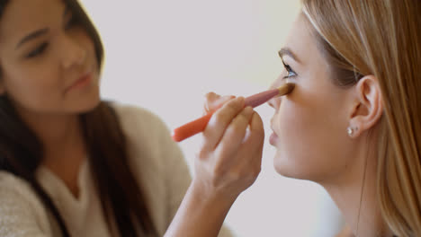 Woman-Putting-Make-up-to-her-Pretty-Friend
