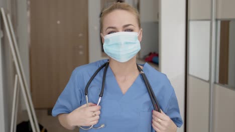 Female-doctor-tired-after-long-shift-taking-off-her-medical-face-mask-with-huge-relief