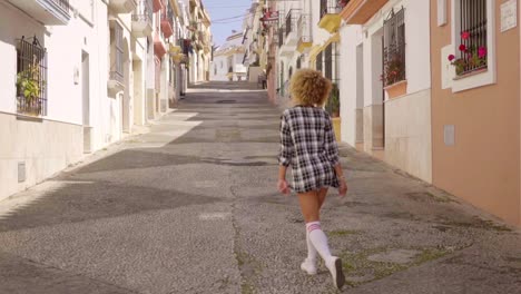 Girl-Walks-The-Mediterranean-Street-Along
