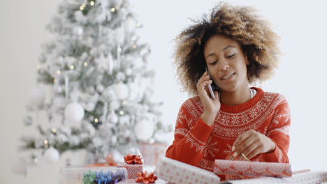 Young-woman-wrapping-gifts-at-Christmas