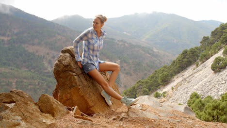 Girl-Resting-Near-Rock-in-Spanish-Mountains