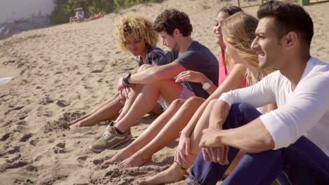 Group-of-multiracial-people-sitting-on-a-beach
