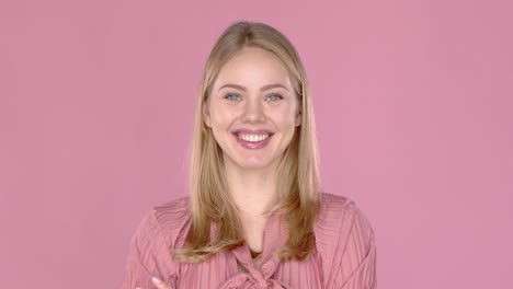 Portrait-of-young-blonde-positive-female-with-cheerful-expression--dressed-in-casual-blouse