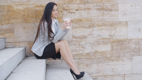 Business-woman-looking-at-coffee-cup