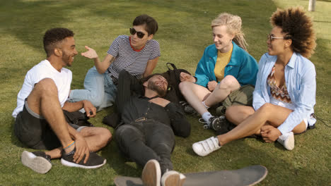 Cool-young-friends-chilling-on-meadow
