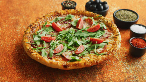 Tasty-pizza-on-a-rusty-background-with-spices--herbs-and-vegetables