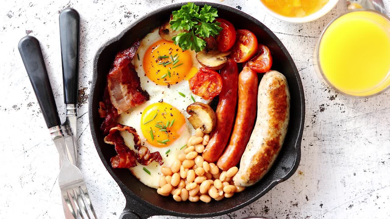 Premium stock video - Delicious english breakfast in iron cooking pan
