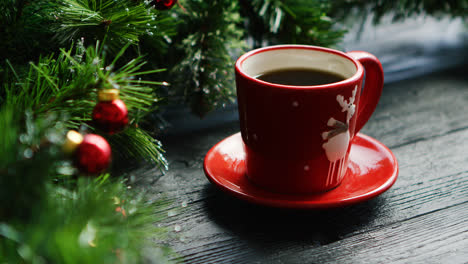 Hot-beverage-near-decorated-conifer-branches