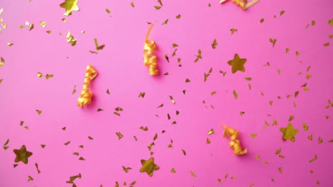 Pink-party-background-with-golden-confetti-and-serpentines
