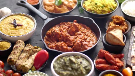 Various-Indian-dishes-on-a-table--Spicy-chicken-Tikka-Masala-in-iron-pan