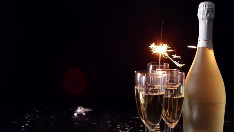 Party-composition-image--Glasses-filled-with-champagne-placed-on-black-table