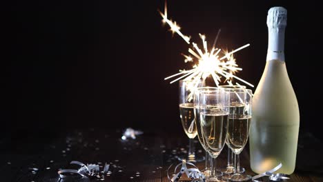 Party-composition-image--Glasses-filled-with-champagne-placed-on-black-table
