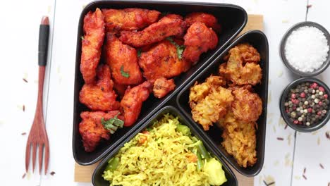 Spicy-indian-fried-chicken-served-with-curry-vegetable-rice--onion-bhajia--naan-bread