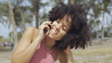 Charming-woman-speaking-on-phone-in-sunlight