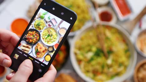 Woman-taking-a-photo-with-her-smartphone--Ready-for-social-media--Asian-food-concept