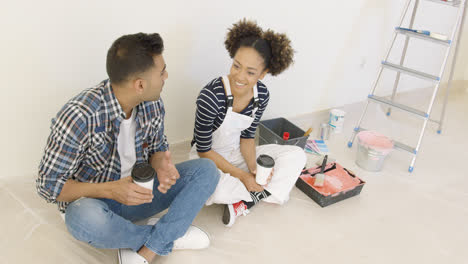 Young-couple-taking-a-break-from-redecorating