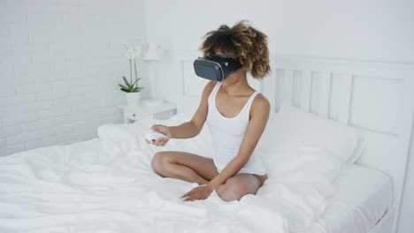 Content-woman-in-VR-glasses-on-bed