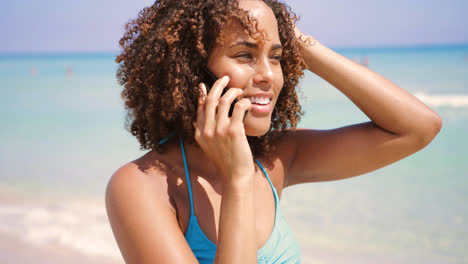Laughing-woman-talking-phone-at-seaside