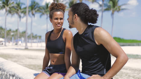 Athletic-couple-sitting-and-resting-after-sports