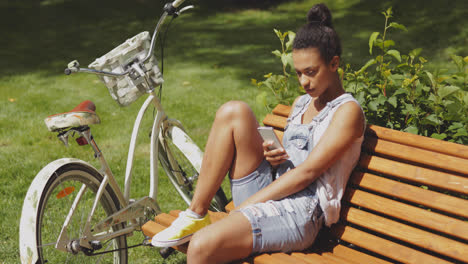 Youngster-with-smartphone-and-bicycle