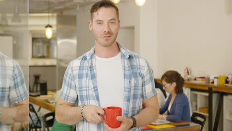 Man-with-coffee-in-office