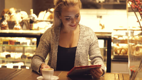 Cheerful-woman-with-coffee-and-tablet