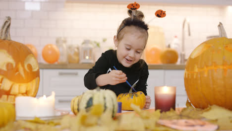 Happy-girl-painting-pumpkin