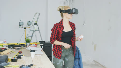 Female-in-virtual-reality-headset-in-workshop-