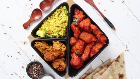 Spicy-indian-fried-chicken-served-with-curry-vegetable-rice--onion-bhajia--naan-bread