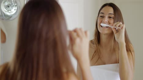 Girl-brushing-teeth-in-morning
