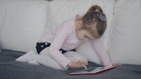 Casual-girl-using-tablet-on-sofa